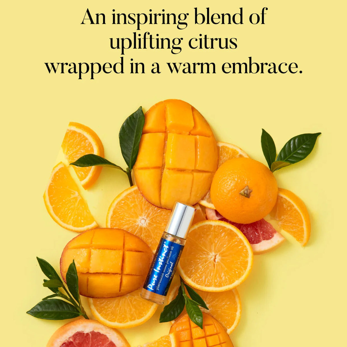 Vial of perfume surrounded by sliced oranges, mangoes, and grapefruits on a yellow background with text.